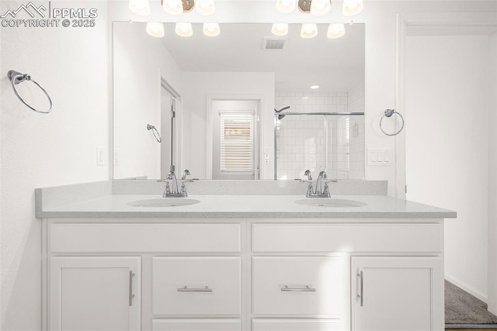 Image 10 of 38: Full bathroom featuring a stall shower and double vanity