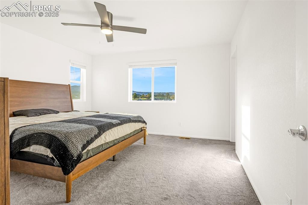 Image 13 of 38: Carpeted bedroom featuring baseboards and ceiling fan