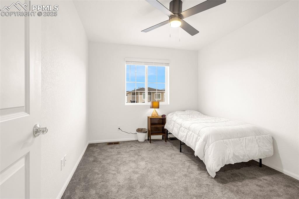 Image 14 of 38: Carpeted bedroom with baseboards and ceiling fan