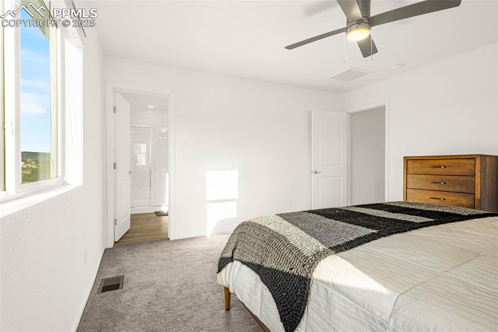 Image 15 of 38: Carpeted bedroom featuring a ceiling fan