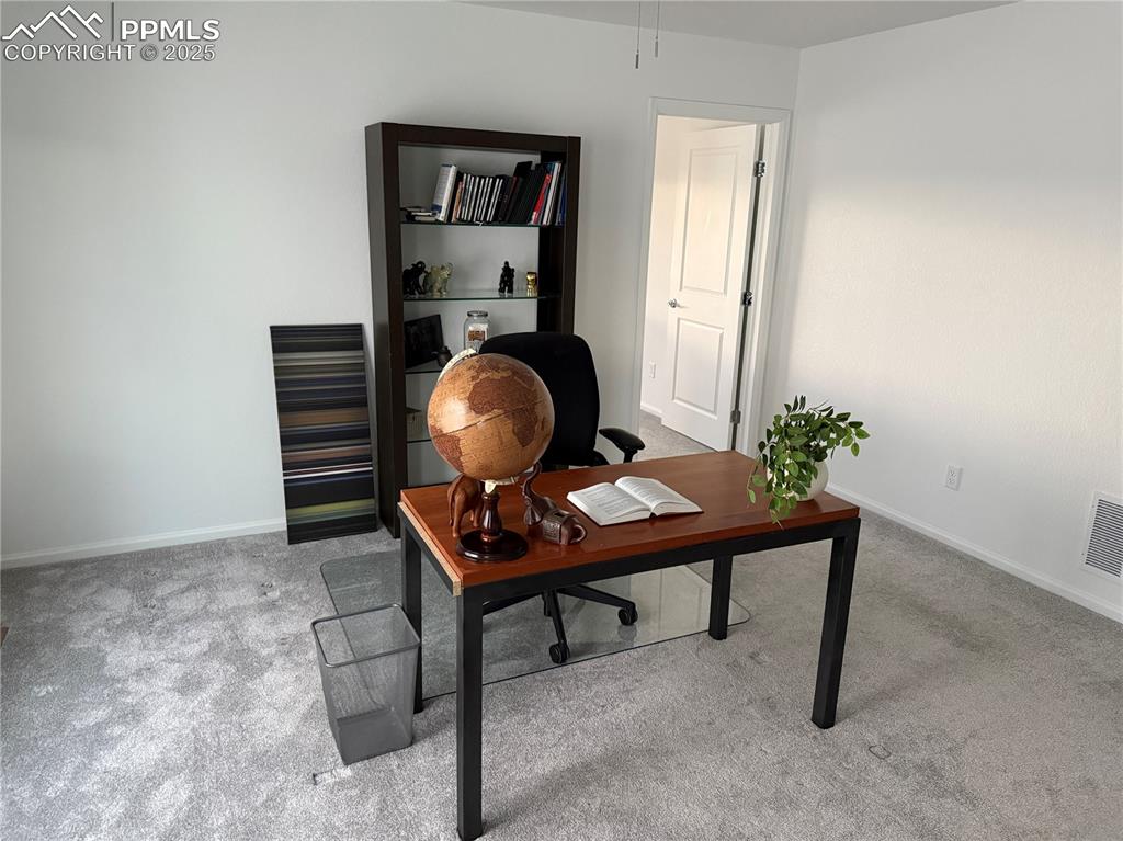 Image 17 of 38: Carpeted office with baseboards
