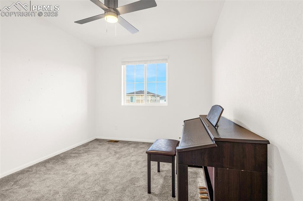 Image 20 of 38: Unfurnished office with carpet, ceiling fan, and baseboards