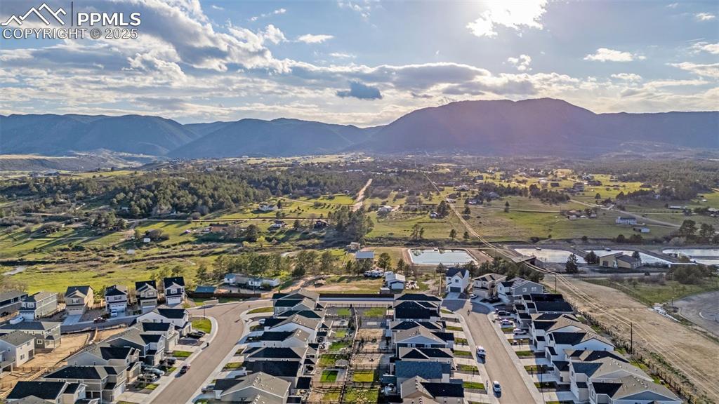 Image 36 of 38: Aerial view of property and surrounding area featuring mountains and nearby