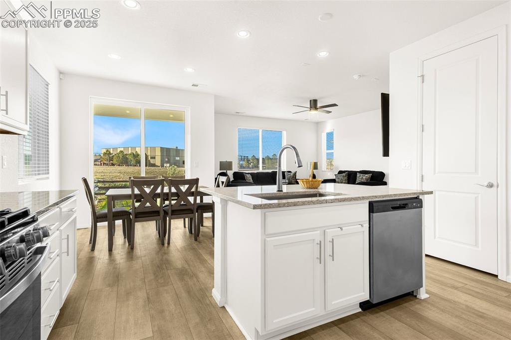 Image 5 of 38: Kitchen with stainless steel dishwasher, a sink, range with gas cooktop, li