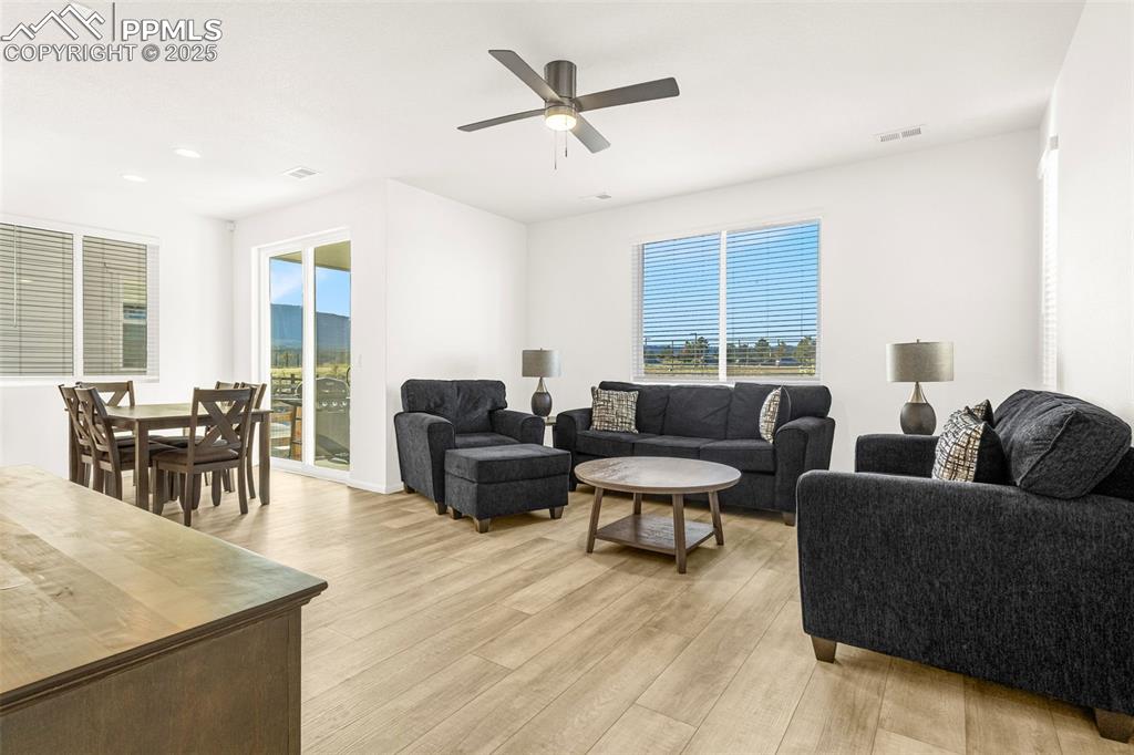Image 8 of 38: Living area featuring light wood-style floors, healthy amount of natural li