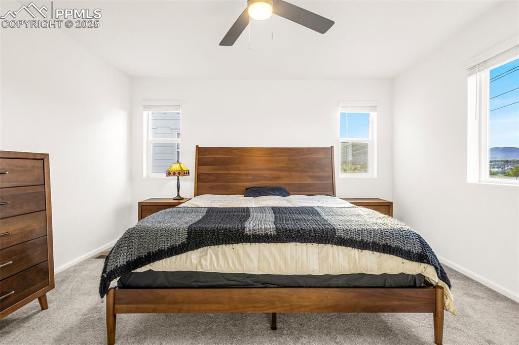 Image 9 of 38: Bedroom with carpet floors, baseboards, and a ceiling fan