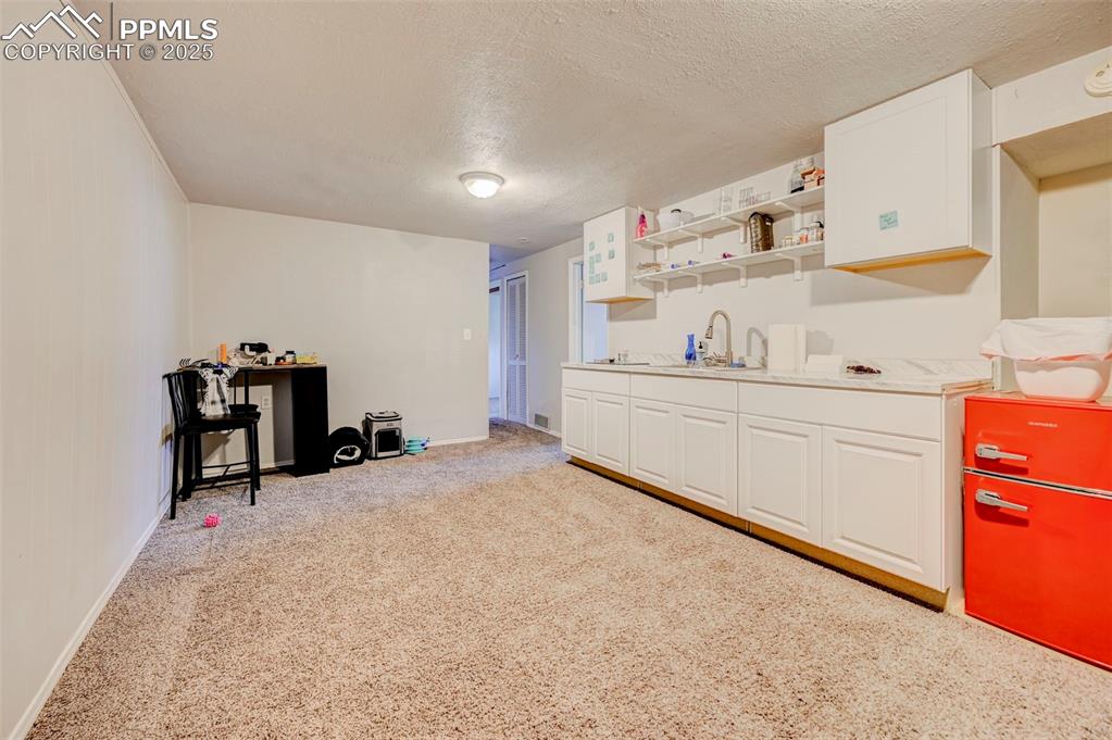 Image 17 of 30: Basement with nonconforming kitchenette