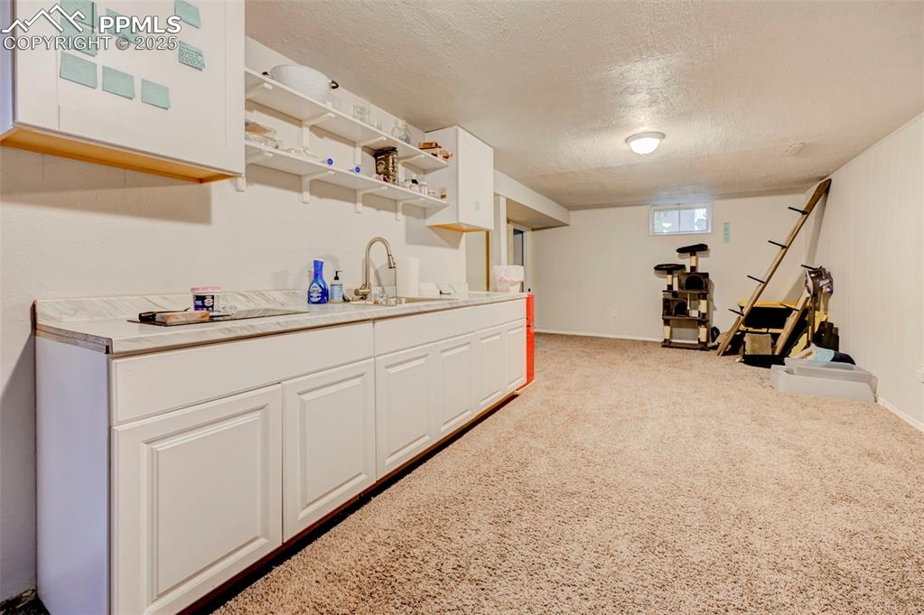 Image 18 of 30: Basement with nonconforming kitchenette