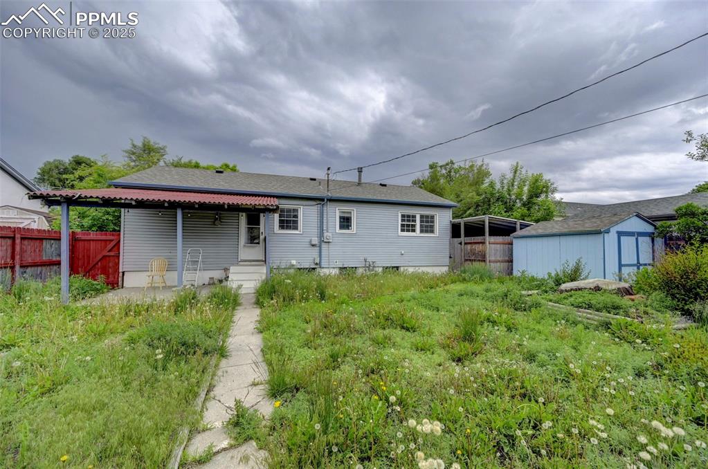 Image 28 of 30: Backyard with patio. Bonus storage shed.