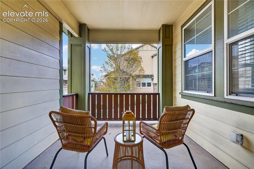 Image 15 of 43: Covered balcony off of living room