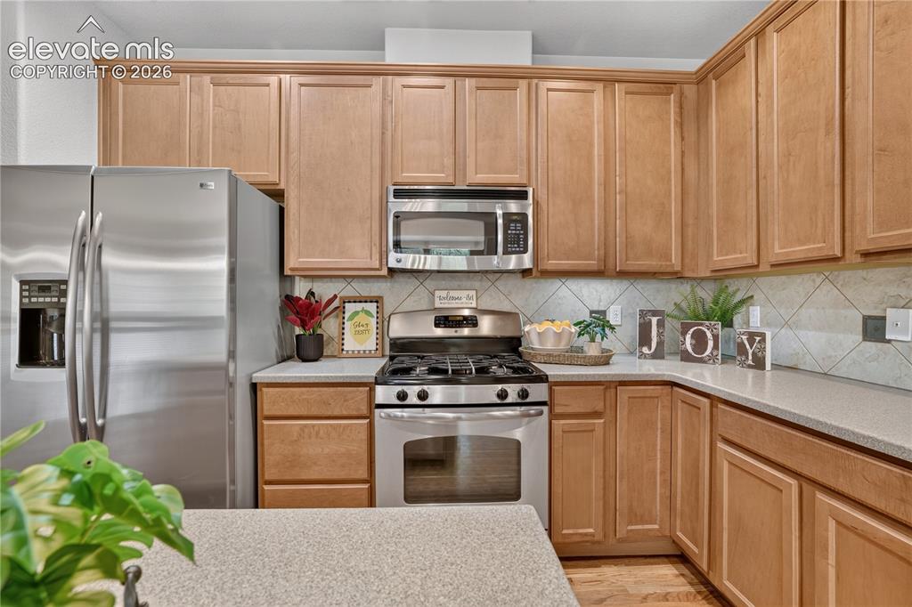 Image 22 of 43: Kitchen featuring light wood-finish cabinetry, stainless steel appliances, 