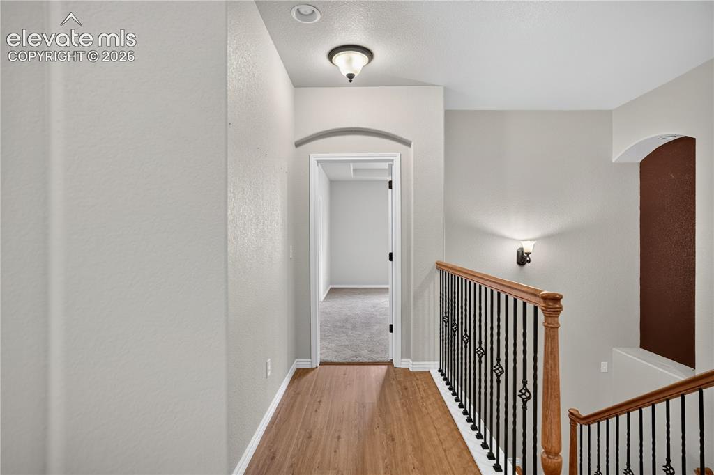 Image 24 of 43: Upper hallway to primary bedroom, new LVP!