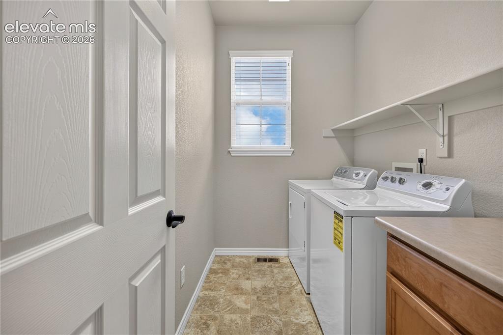Image 32 of 43: Laundry on upper level by the bedrooms. with built in cabinet and shelf.