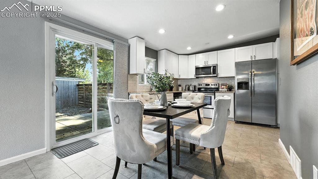 Image 10 of 35: Dining Area and Kitchen with slider to the backyard.