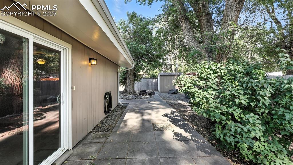Image 11 of 35: Side patio located off the Kitchen and Dining Area.