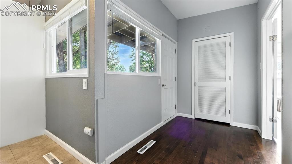 Image 6 of 35: Front entry with wood flooring.