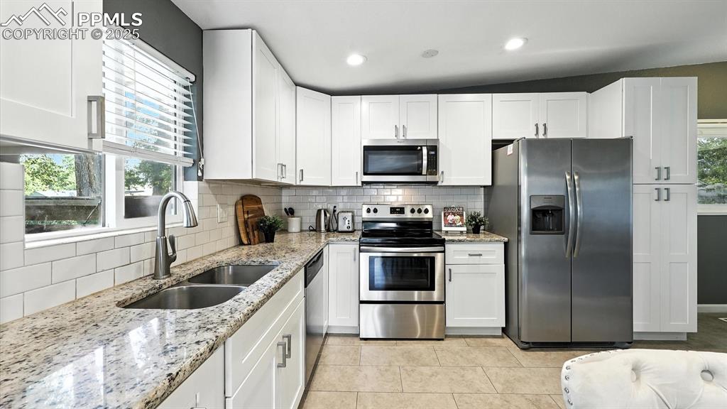 Image 8 of 35: Stainless steel appliances include a range oven, built-in microwave, dishwa