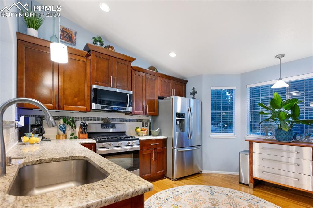 Image 13 of 49: Kitchen featuring pendant lighting, appliances with stainless steel finishe