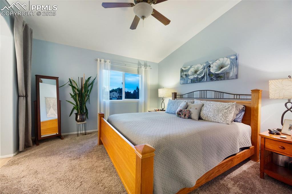Image 19 of 49: Bedroom featuring carpet, lofted ceiling, and a ceiling fan