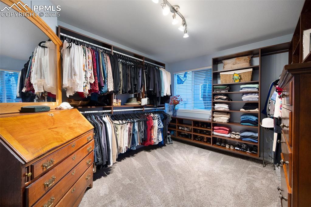 Image 21 of 49: Spacious closet featuring California style cabinetry and shelving
