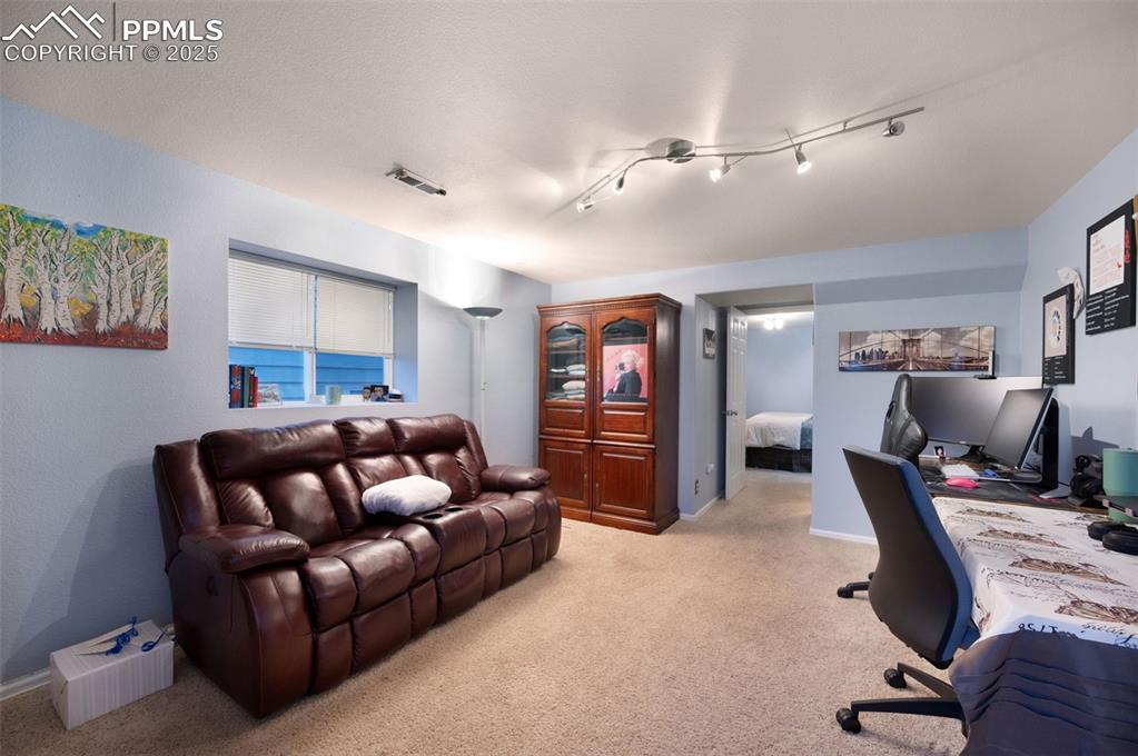 Image 30 of 49: Office featuring light colored carpet