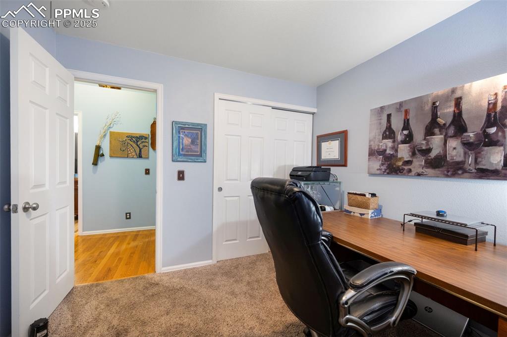 Image 31 of 49: Office with light carpet and baseboards