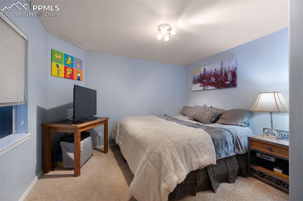 Image 33 of 49: Bedroom with light colored carpet