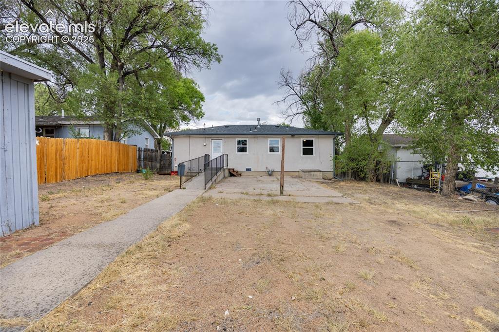 Image 15 of 17: Fenced backyard with RV parking off the alley