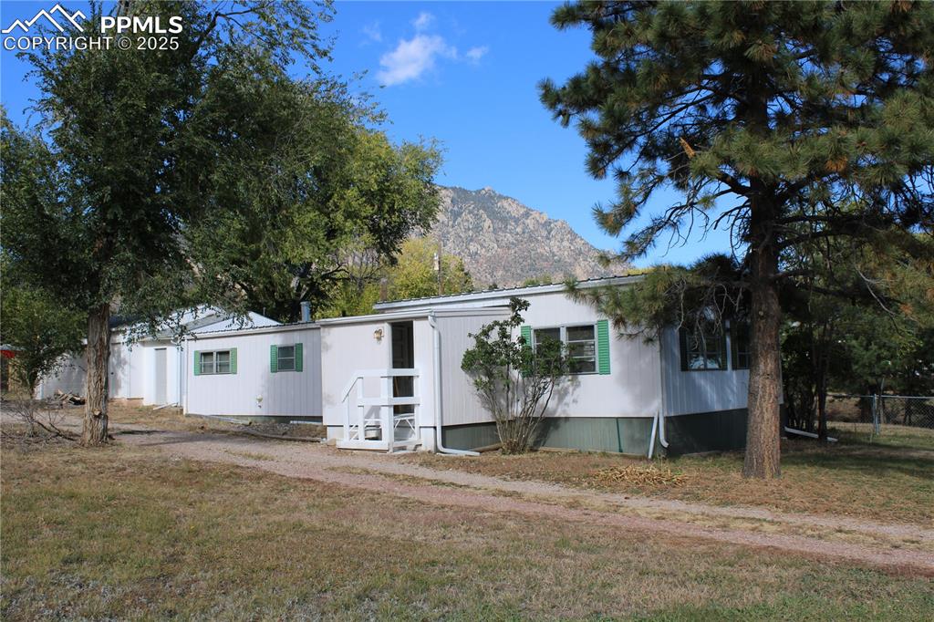 Caption: Manufactured / mobile home with a mountain view and a front yard