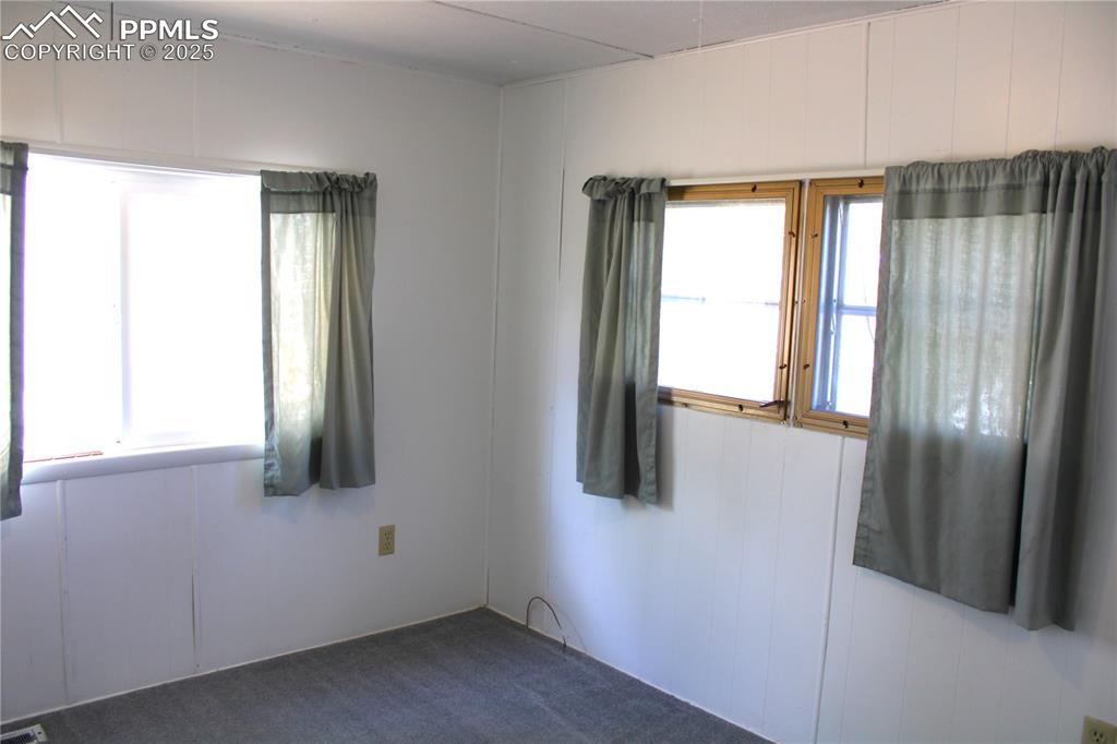 Image 13 of 20: Unfurnished room featuring carpet flooring