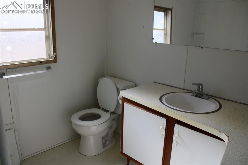 Image 17 of 20: Half bath featuring vanity and light flooring