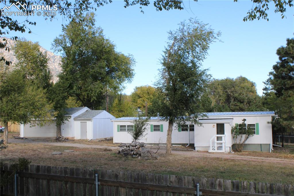 Image 18 of 20: Back of house featuring a metal roof