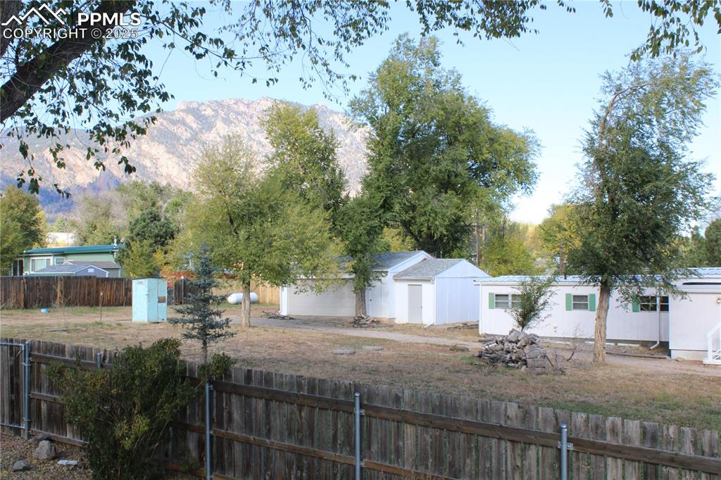 Image 20 of 20: View of front of house featuring a mountain view and a fenced backyard