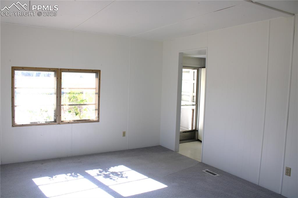 Image 6 of 20: Carpeted empty room featuring plenty of natural light