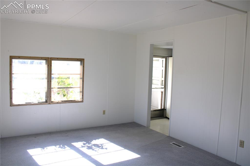 Image 6 of 20: Carpeted living room featuring plenty of natural light