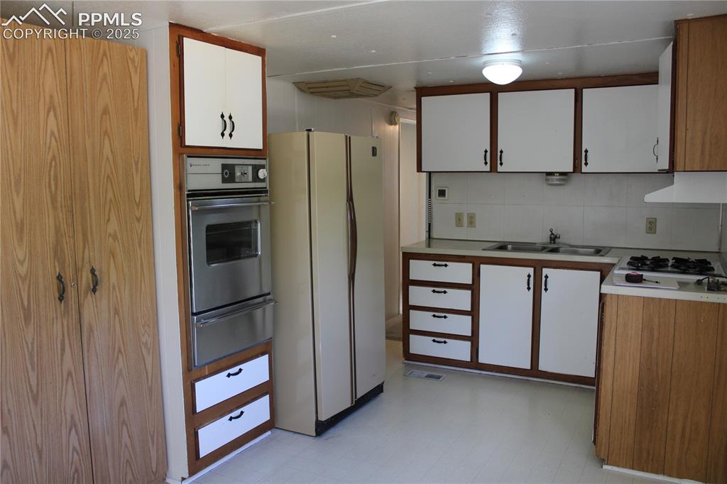 Image 9 of 20: Kitchen featuring white cabinetry, light flooring, light countertops, white