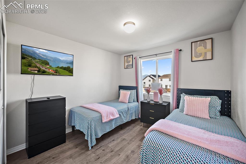 Image 16 of 36: Bedroom featuring wood finished floors and baseboards