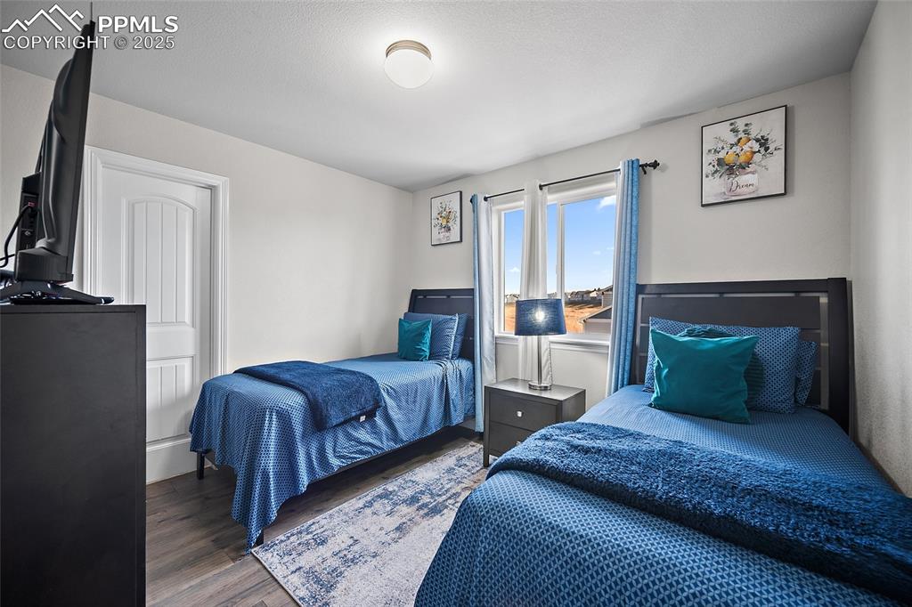 Image 18 of 36: Bedroom with wood finished floors