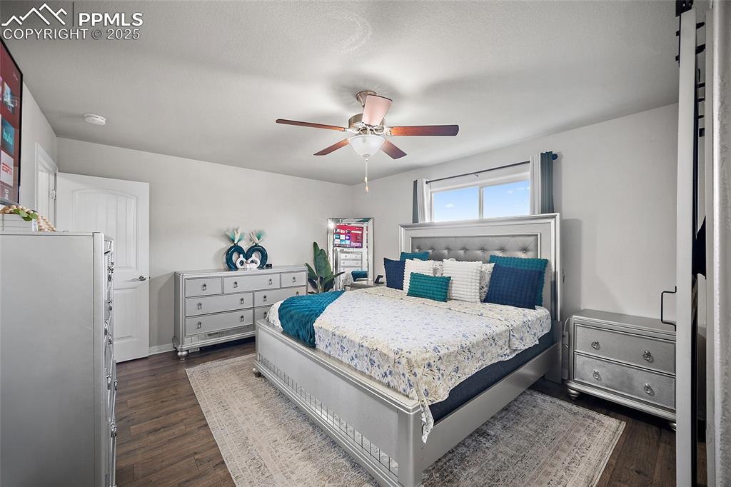 Image 21 of 36: Bedroom featuring dark wood-style flooring and ceiling fan