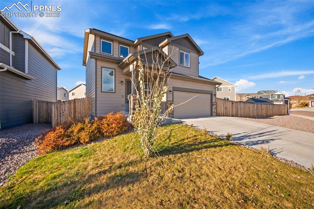 Image 3 of 36: View of front of house with concrete driveway and a garage