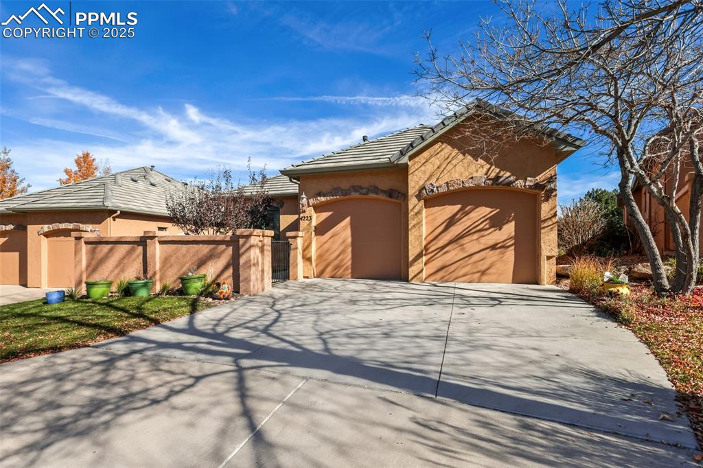 Caption: Stucco exterior with stone accent and tile roof