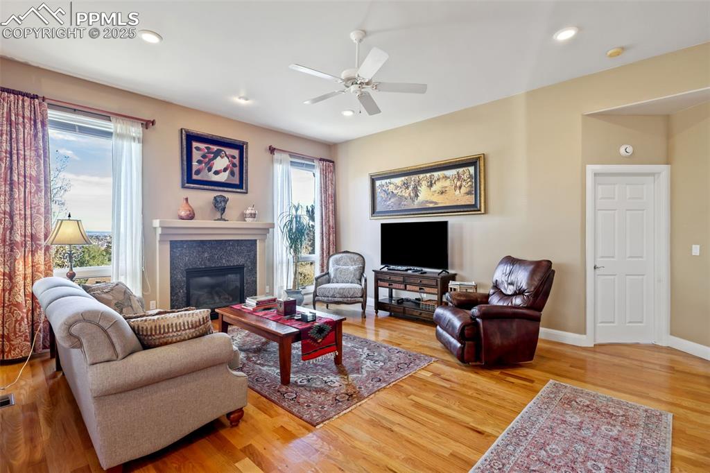 Image 8 of 37: Large living room with fireplace and hardwood floors