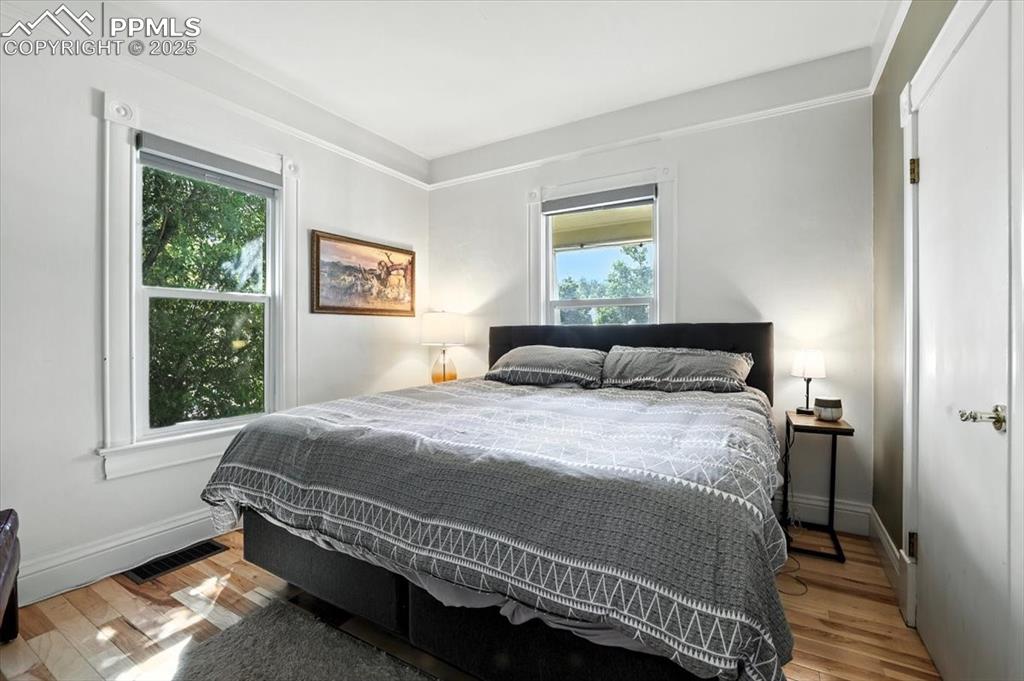 Image 11 of 48: Bedroom featuring light wood-style flooring and baseboards