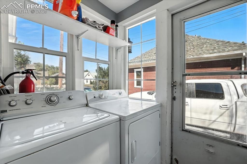 Image 15 of 48: Laundry area featuring plenty of natural light and washing machine and clot