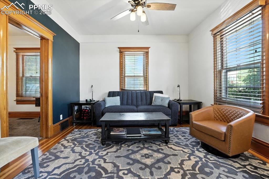Image 20 of 48: Living area with wood finished floors, plenty of natural light, and ceiling
