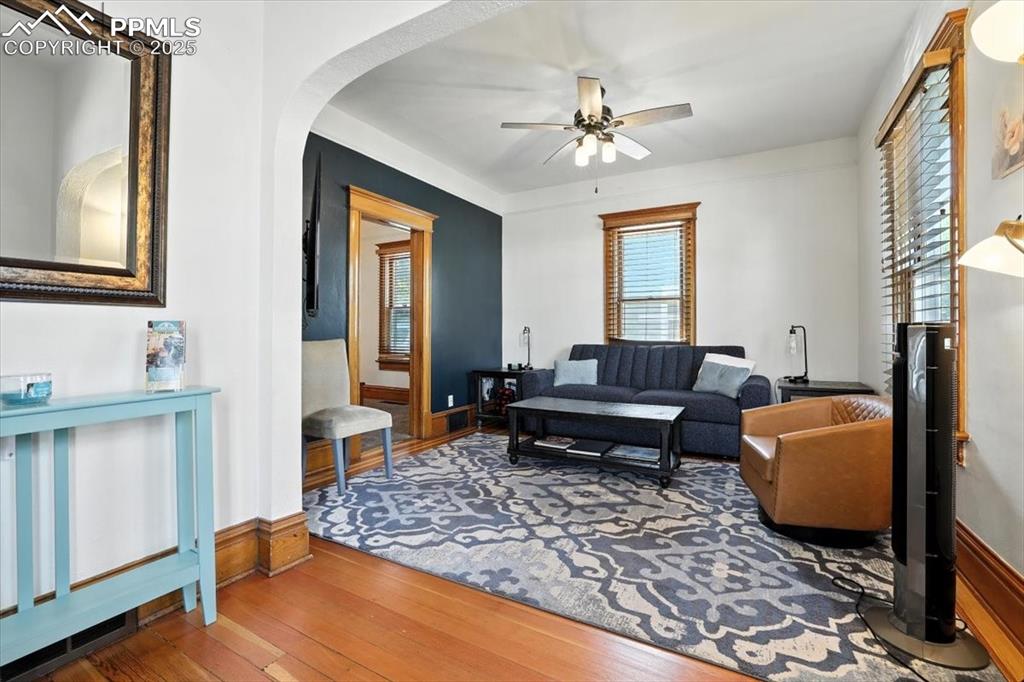 Image 21 of 48: Living area with hardwood / wood-style flooring, arched walkways, and ceili