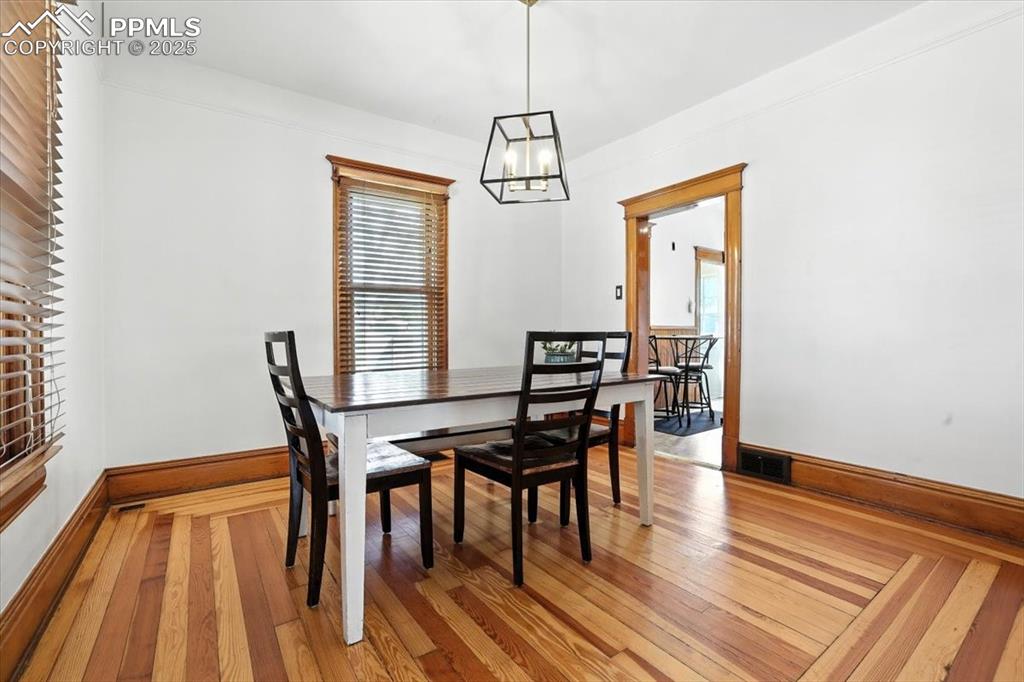 Image 23 of 48: Dining space with light wood-type flooring and a chandelier