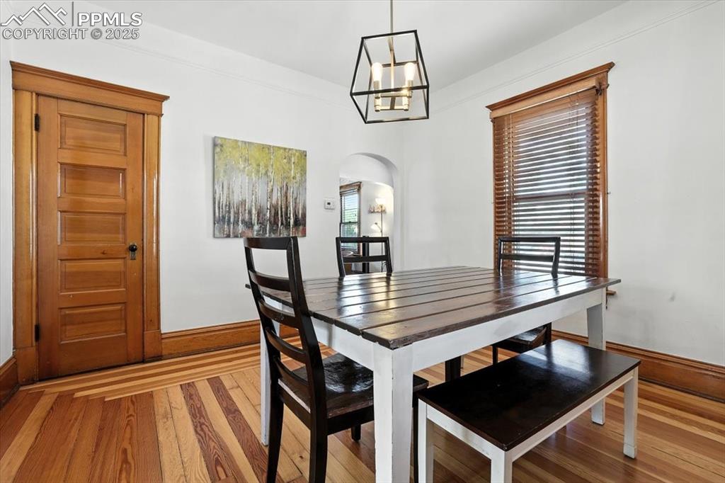Image 24 of 48: Dining area featuring light wood-style flooring and arched walkways