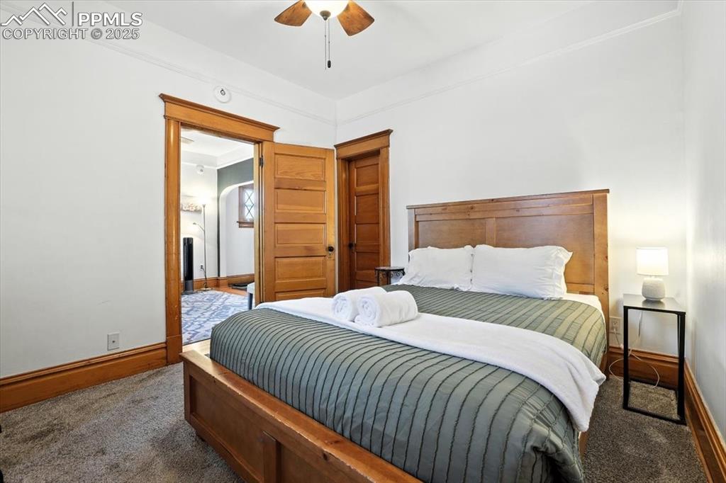 Image 28 of 48: Bedroom featuring dark colored carpet and ceiling fan