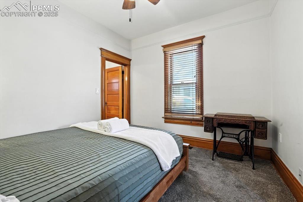 Image 29 of 48: Bedroom featuring ceiling fan and carpet floors